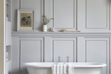 20 a neutral bathroom with grey paneled walls looks cool and refined