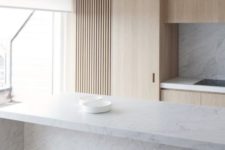 21 a minimalist kitchen is done with light-colored wood and marble to make it more interesting