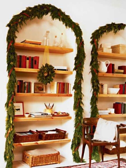 an evergreen garland with ornaments and red ribbon to cover the built-in niches