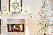 22 a lush snowy evergrene garland with a matching wreath, cone Christmas trees and ornaments in a jar for an elegant look