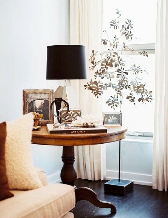 a vintage wood pedestal table used as a side on eis a chic idea for any interior and looks very cool