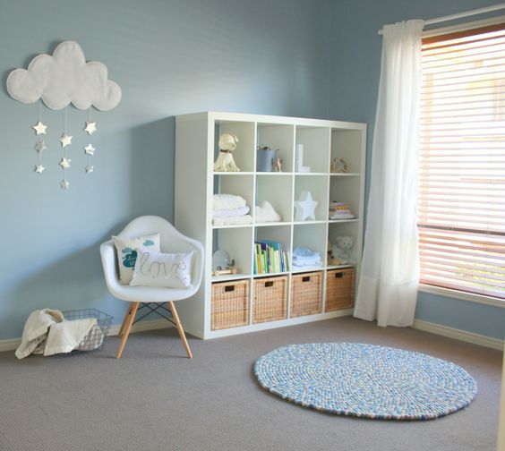 a comfy IKEA dresser with open shelves and baskets for toys looks pretty