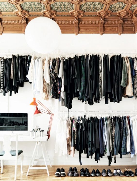 a man's makeshift closet is placed in the home office makes it unique and creative