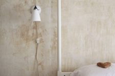 25 a simple white sconce with a classic shape will fit most bedroom styles