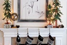 25 cute printed stockings in black and white, Christmas trees made of fir branches and lights for a woodland feel