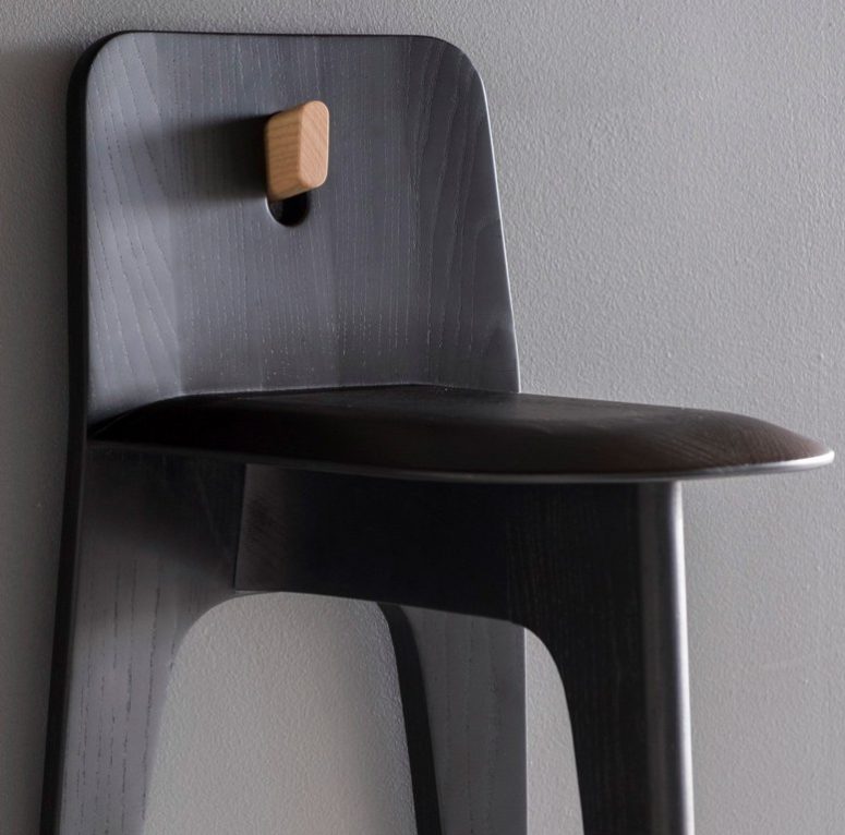 Stove chair is minimalist piece with three legs, clean lines and simple aesthetics