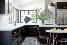 01 The kitchen is done in the classic color palette of black and white, with skylights and windows to bring natural light in
