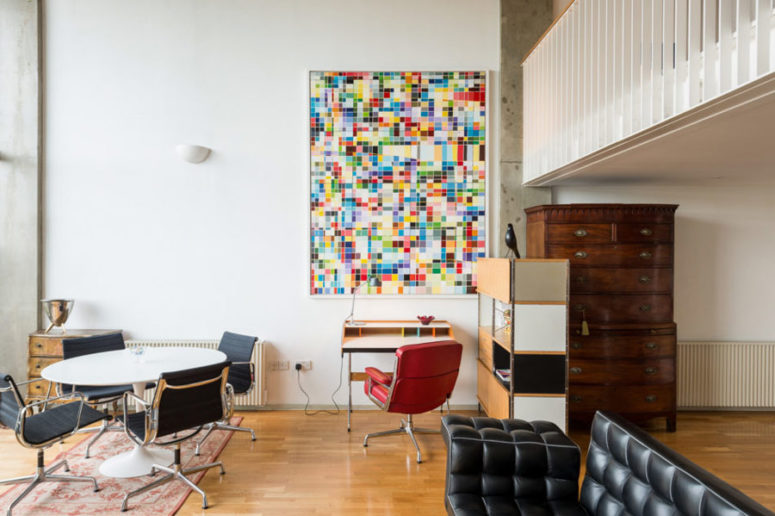 This eclectic mid century modern loft features two levels, there are interesting colorful artworks and exquisite furniture