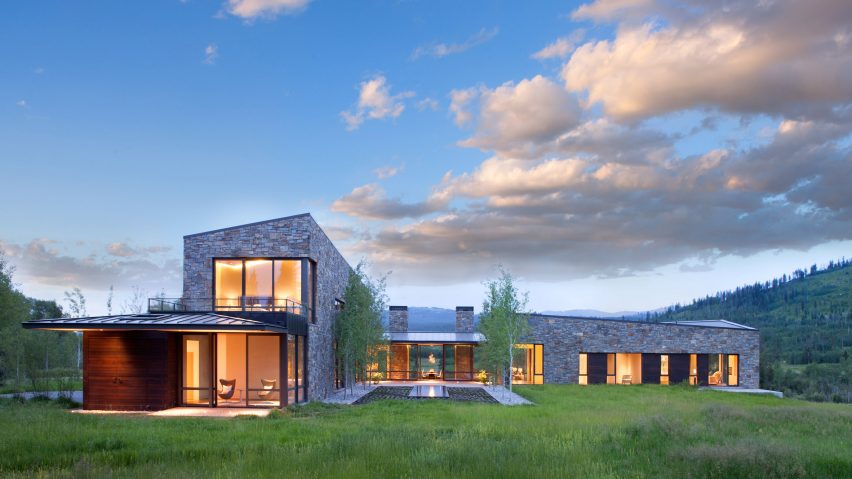 This large Wyoming residence is clad with stone and wood features amazing views of the beautiful nature around