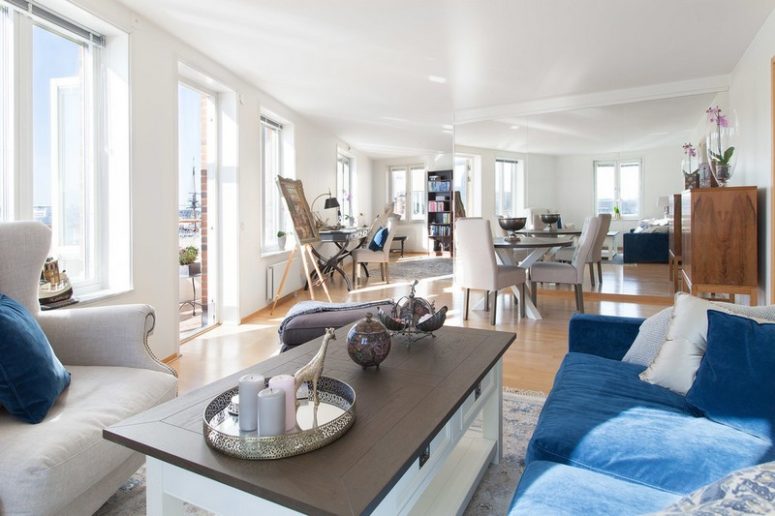 The dining-living zone is the main space here, modern comfy furniture blends with some antique finds