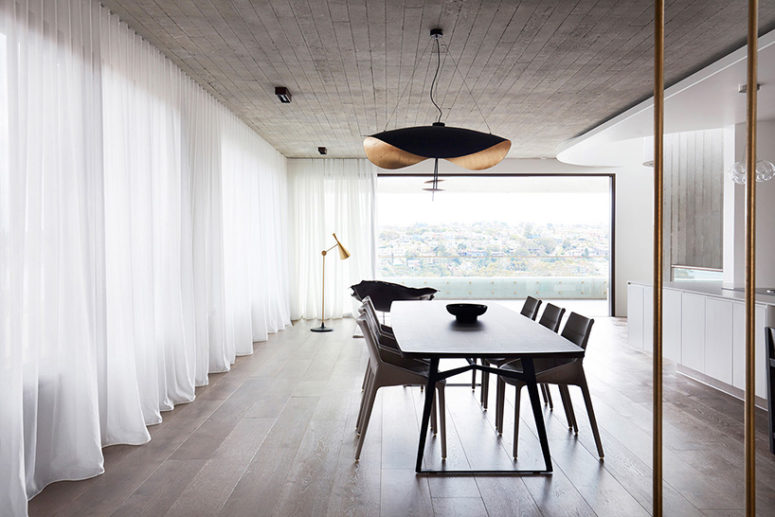 The interiors are modern and uncluttered, like this dining space and kitchen done with lots of natural wood and a glazed wall The interiors are modern and uncluttered, like this dining space and kitchen done with lots of natural wood and a glazed wall