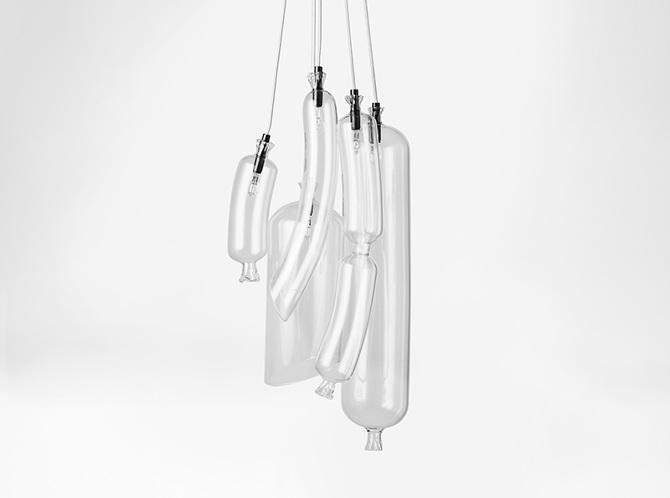 The lamps are made of glass, and it highlights the shapes of the sausages