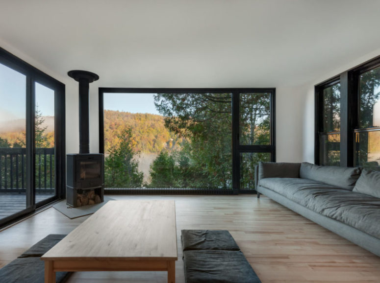 The living room is connected to this zone, it features much glazing and simple furnishings plus a metal hearth The living room is connected to this zone, it features much glazing and simple furnishings plus a metal hearth