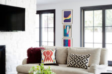 03 The small living room is done with neutral upholstered furniture, an acrylic table and there’s much light