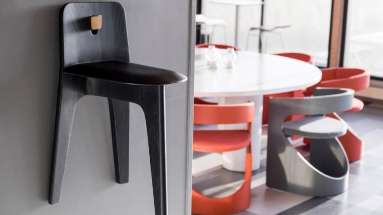 There's a hole in the backrest to hang the chair on the wall when not in use