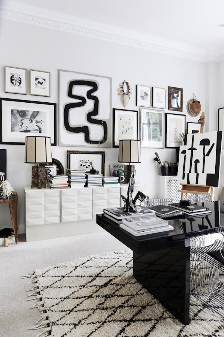 There's a large sideboard with a textural surfaces, which holds books and magazines