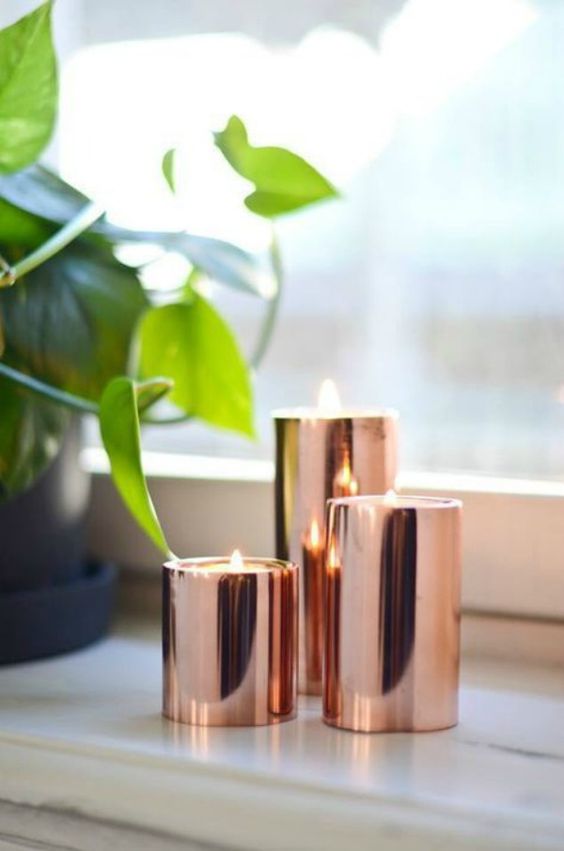 an arrangement of copper candle holders is a chic addition to any space
