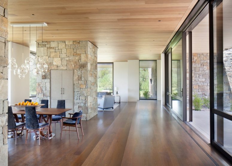 The color palette is neutral, and the materials used are natural - cedar, stone and just some metal