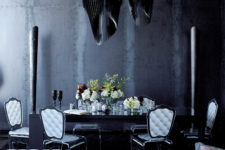 04 The dining space is defined with black sculptural chandeliers and metal pillars