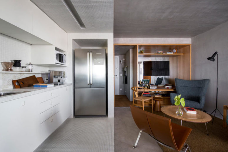 The living room is united with a kitchen and dining zone