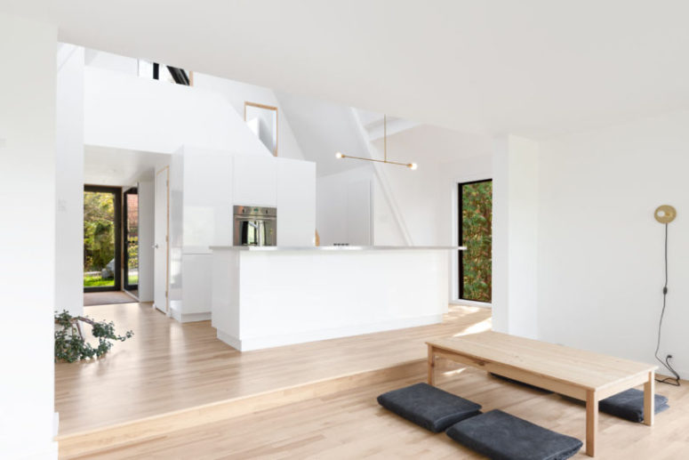 The living room is united with a kitchen and the spaces are divided into two parts with a different floor level The living room is united with a kitchen and the spaces are divided into two parts with a different floor level
