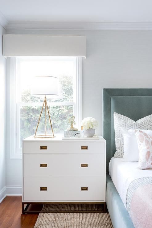 a sleek white dresser will fit many bedroom styles and looks and metallic handles
