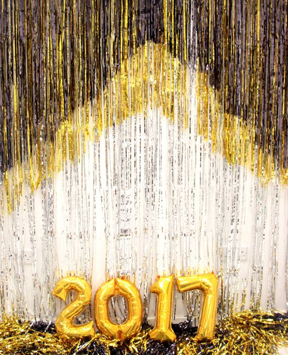 a sparkling fringe photo booth and number balloons, which are essential for a New Year's party