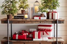 04 evergreen trees in baskets and gifts and candle lanterns for a festive feel