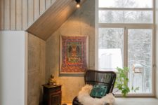 05 There’s a comfy reading nook with a wicker chair and a boho rug