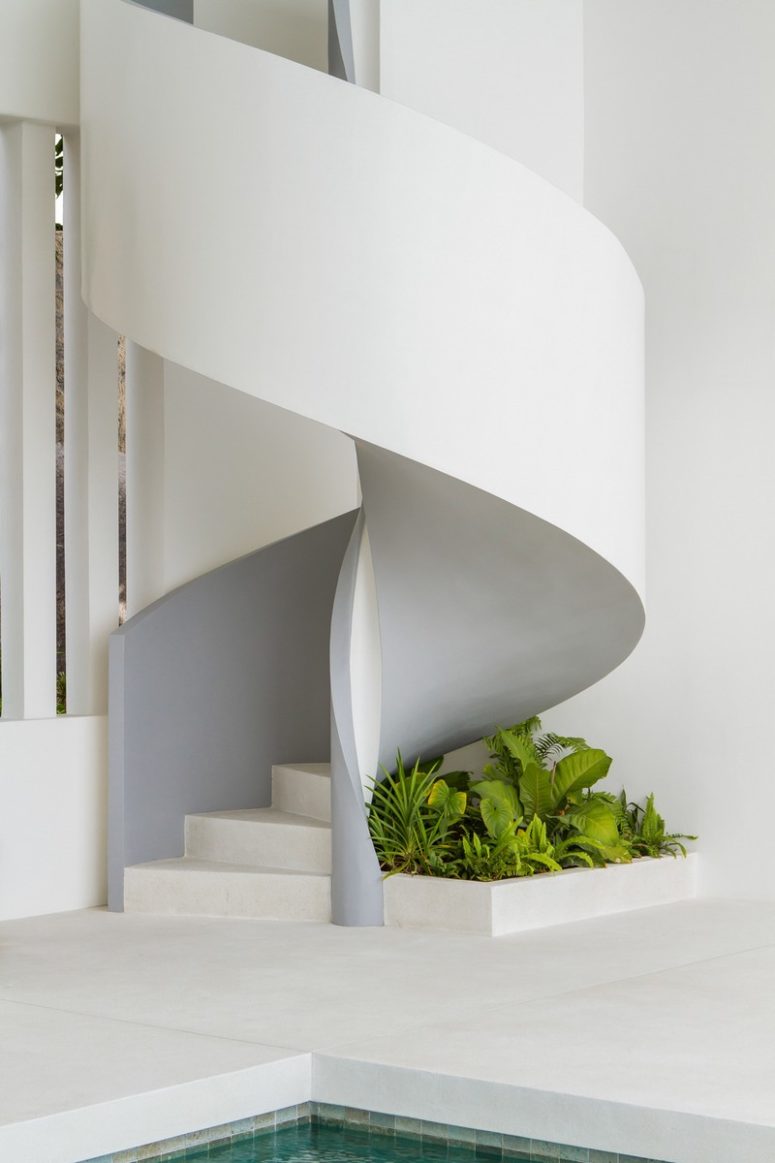 Under the sculptural staircase you'll see fresh greenery growing