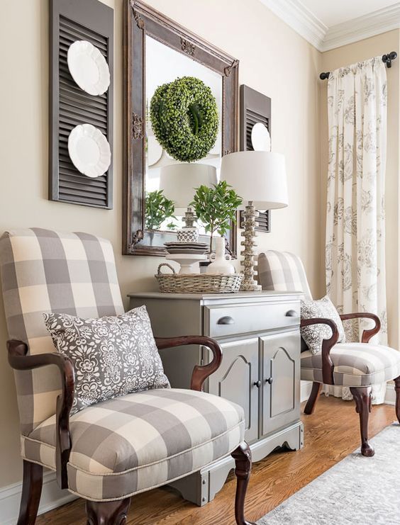 a vintage barn-inspired living room with neutral buffalo check chairs with an exquisite feel