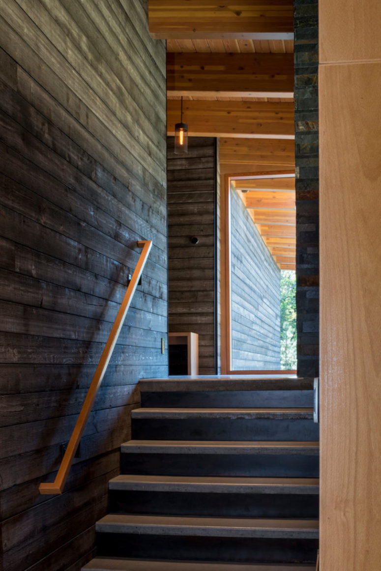 Concrete, stone and wood sections connect the three volumes of the home that are under one roof