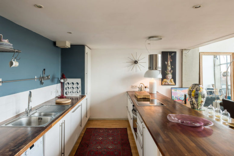 You can see some artworks and a large kitchen island that can be used for cooking and having meals