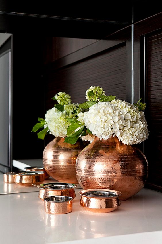 a copper vase and some cute copper catch all trays will add chic to your entryway or bedroom