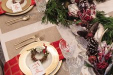 06 a traditional tablescape with red touches, pinecones, candles and evergreens for those who love classics