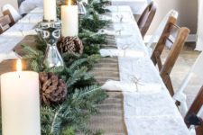 07 a burlap table runner, an evergreen garland, candles and large pinecones for a cozy rustic feel