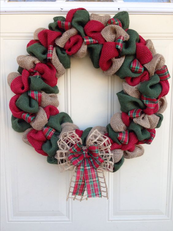 a traditional red, green and neutral burlap wreath with a double bow for a front door