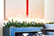 07 an evergreen garland, lots of candles and a gift artwork over the console look super chic