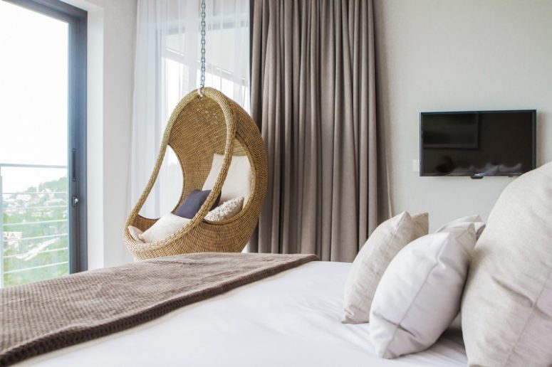 A rattan chair hanging in the bedroom is a cool and fresh idea