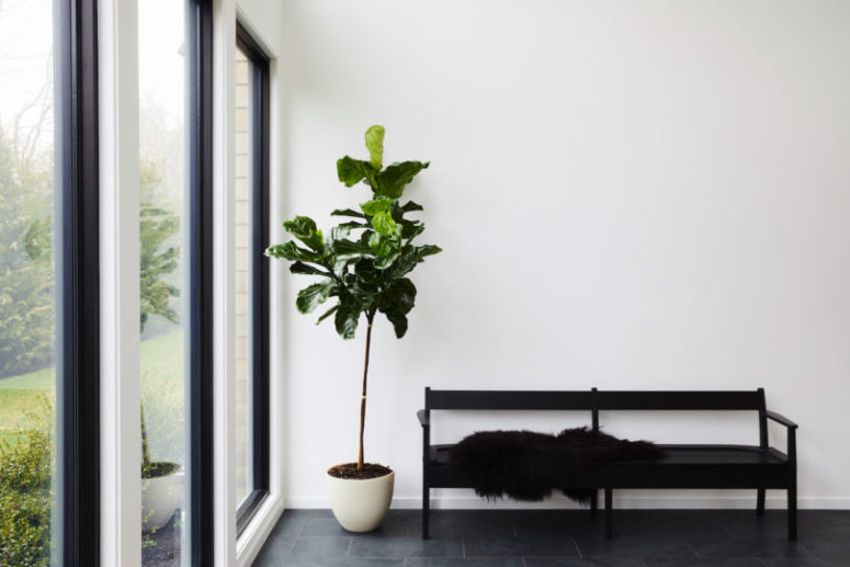 The entryway is done with a simple black bench and some faux fur