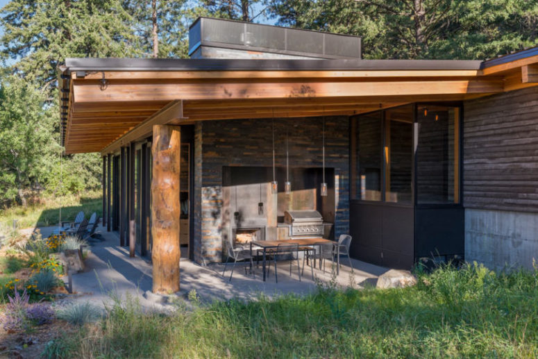 There's an outdoor kitchen and dining zone, which is done in the same style, materials and colors as inside