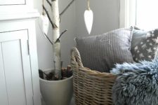 08 a basket with faux fur and pillows for a Scandinavian bedroom