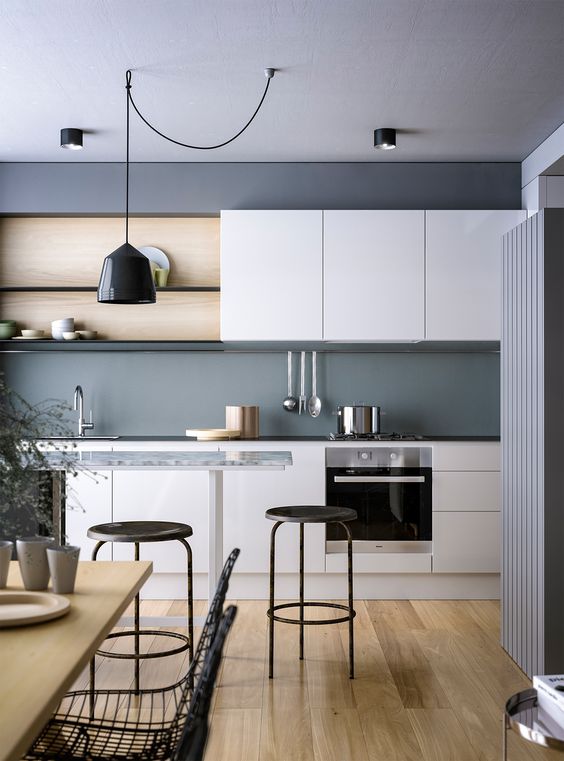 a beautiful kitchen in graphite grey and white plus light-colored wood and black lamps