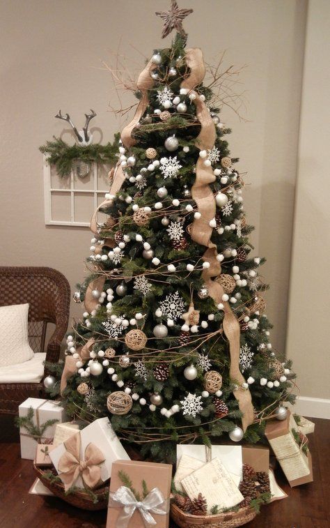 a chic Christmas tree decorated with silver snowflakes, pompoms, pinecones and burlap ribbons