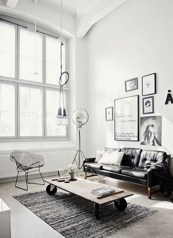 a chic black leather sofa is a harmonious part of this Scandinavian space