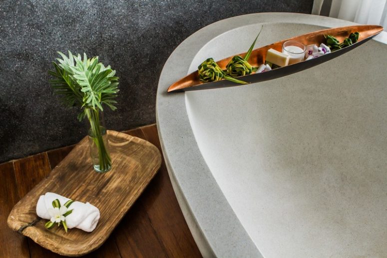 A natural stone bathtub is sure to leave a spa feel and natural wood adds to the space, too