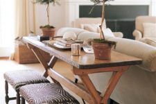 09 a rustic wooden console table with meal contouring to add a rustic feel to your living room