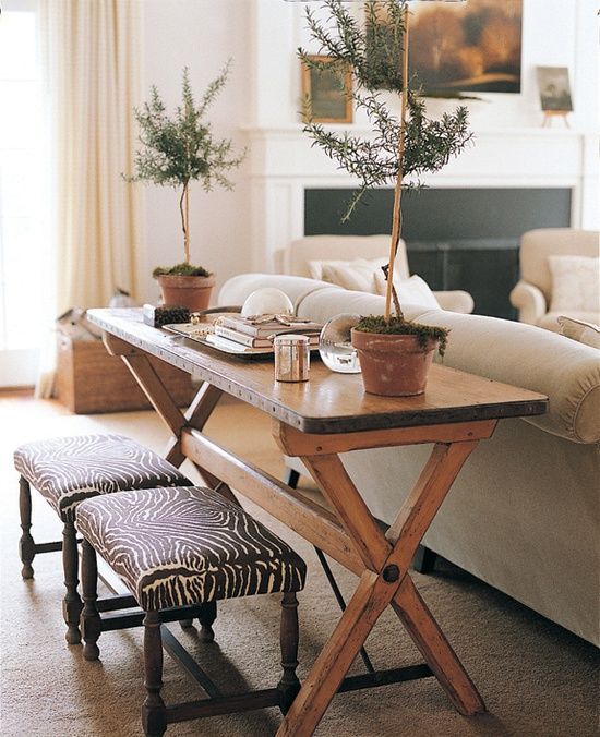 a rustic wooden console table with meal contouring to add a rustic feel to your living room