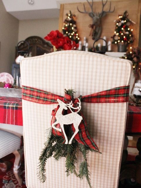 plaid ribbons with evergreens and deer for chair decor and a plaid tablecloth