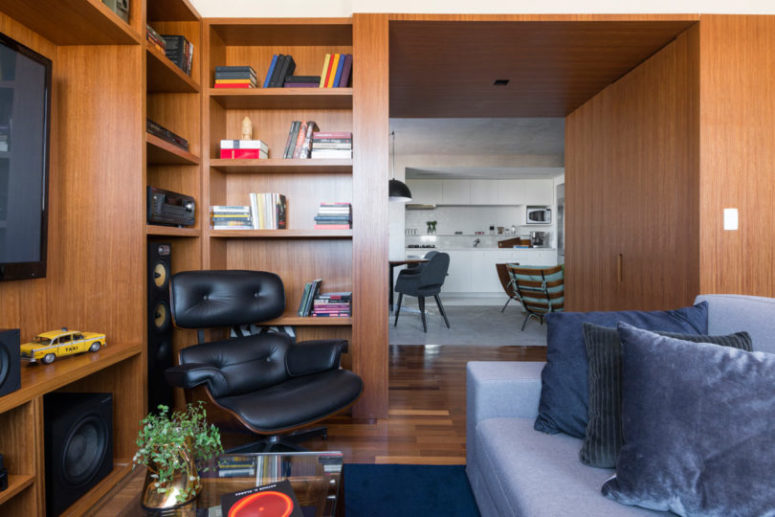 There's a TV and shelves plus a sofa, a coffee table - this is a small lounge zone